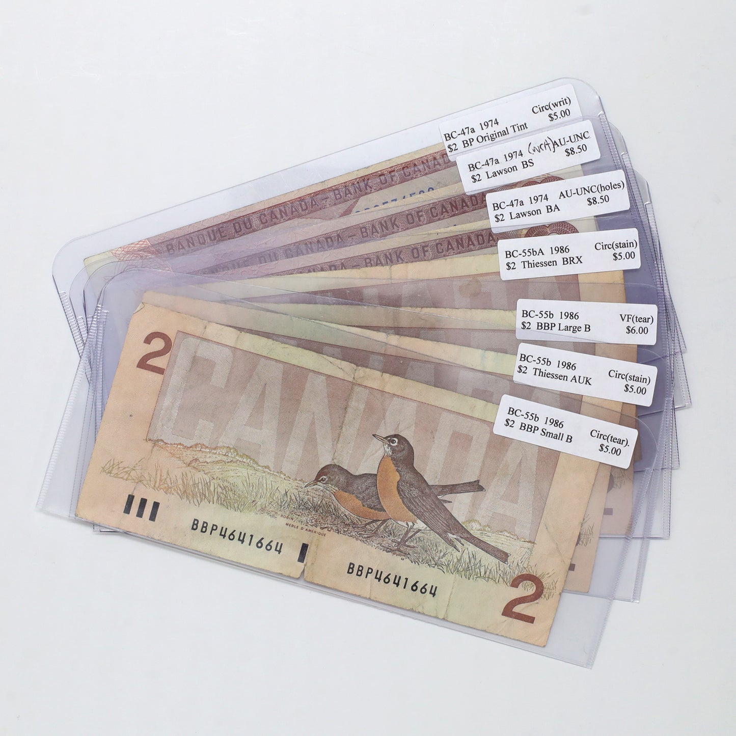 Lot of 7x 1974 & 1986 Canada $2 Banknotes, Circ. to AU-UNC (holes, writing, impairments)